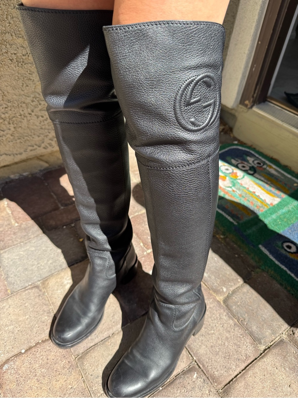 Gucci Black Pebbled Leather women’s over the knee boot with Embossed Gucci Logo